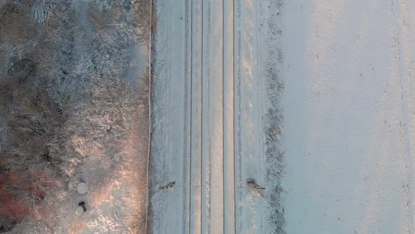 Aerial footage flying up and train passing in snow landscape