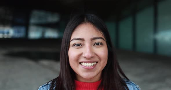 Happy latin woman smiling on camera