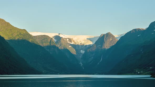 Scenic View Of Briksdalsbreen Glacier Behind Mountain Ridges Surrounding Olden Lake In Norway. - Tim