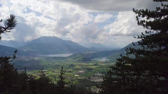 Reveal type aerial panoramic view of Borgo Valsugana in Trentino, Italy with drone passing through s