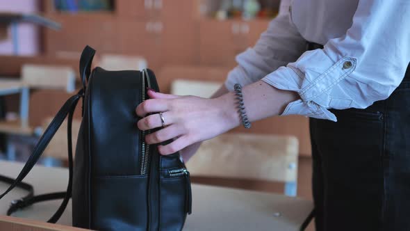 The Student Takes Books From the Bag in Preparation for the Lessons