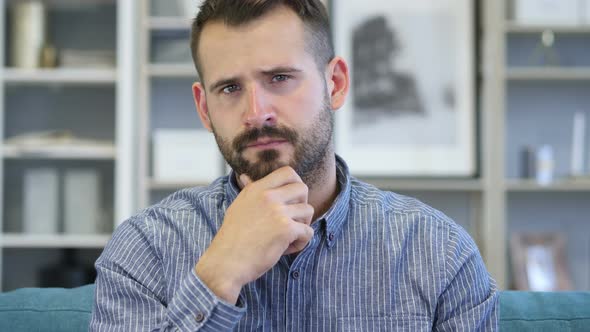 Portrait of Thinking Middle Aged Man in Office