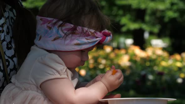 Little baby girl learning to eat by herself