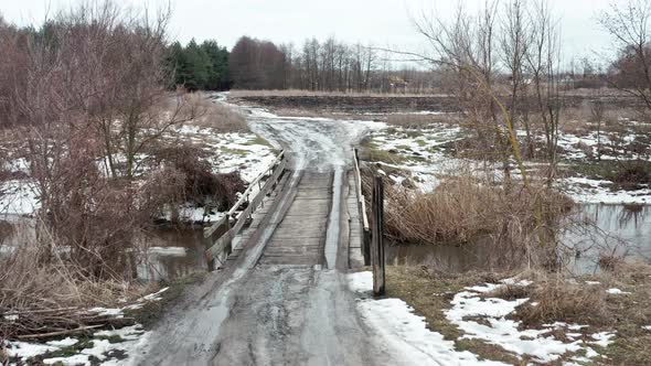 Crossing the River Over a Wooden Bridge in the Spring