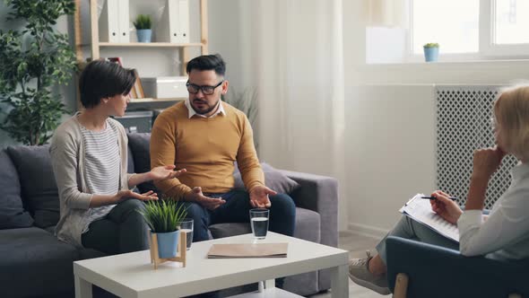 Girl and Guy Married Couple Fighting During Counseling While Doctor Listening