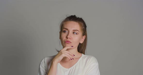 Portrait of a Young Woman Who is Thinking and Cannot Make a Decision