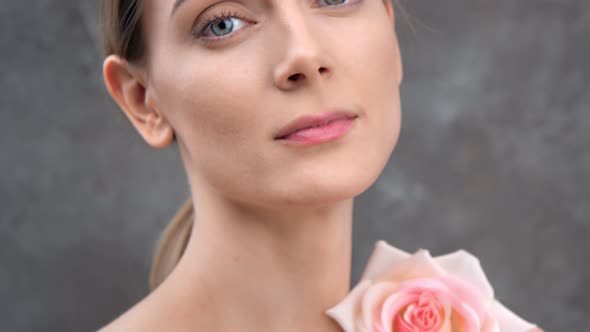 Closeup Portrait Charming Girl Stroking Bare Body with Pink Spring Flower