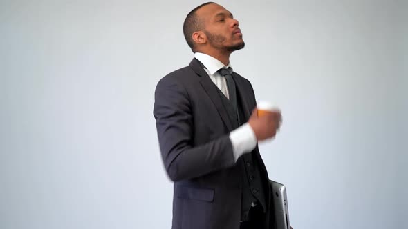 Professional African-american Business Man Holding Laptop Computer and Cup of Take-away Coffee