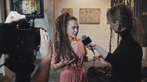 Female Artist Giving Interview on Exhibition