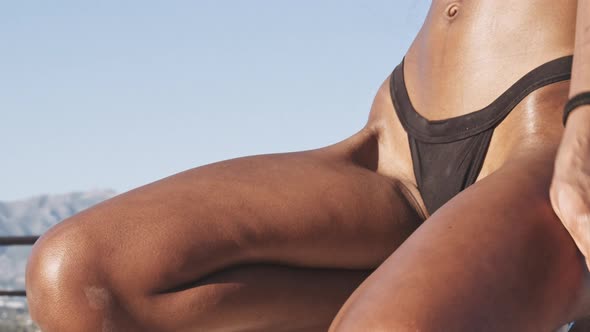 Beautiful Young Black Woman Kneeling At Poolside