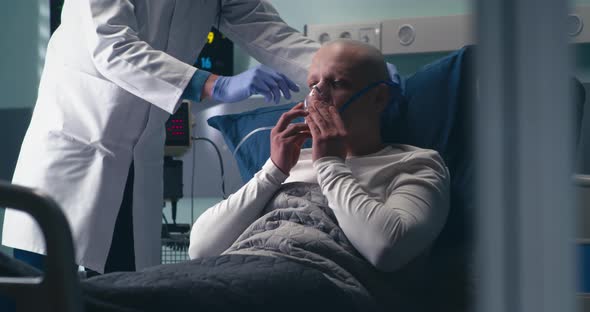 Doctor Supplying Cancer Patient with Oxygen