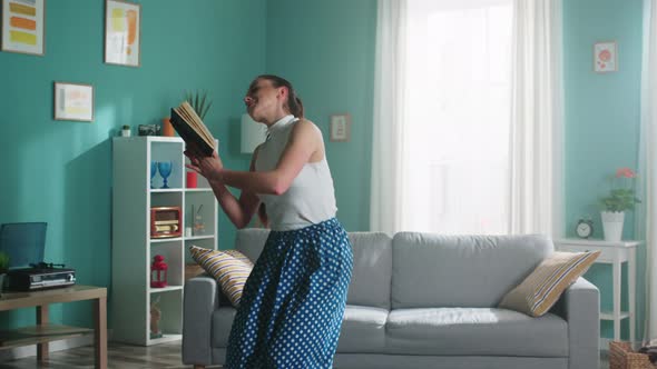 Young Woman Is Dancing With Book
