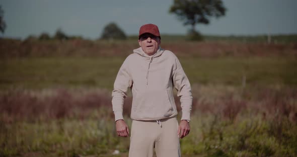 Senior Man Exercising Outdoors in Autumn Sunny Day