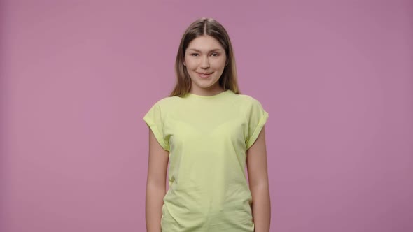 Portrait of a Model with Natural Beauty Coquettishly Looking at Camera and Smiling