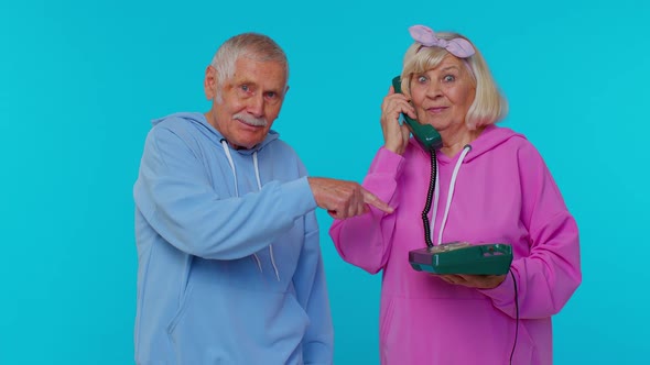 Senior Grandparents Pensioners Talking on Wired Vintage Telephone of 80s Says Hey you Call Us Back