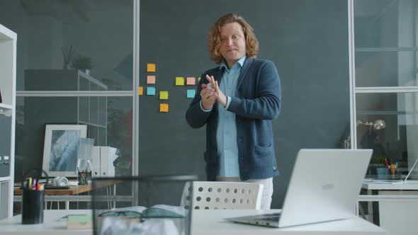 Portrait of Happy Businessman Having Fun at Work Throwing Paper Balls in Basket