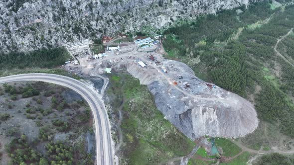 Heavy machinery drills tunnel through the mountain aerial view 4 K