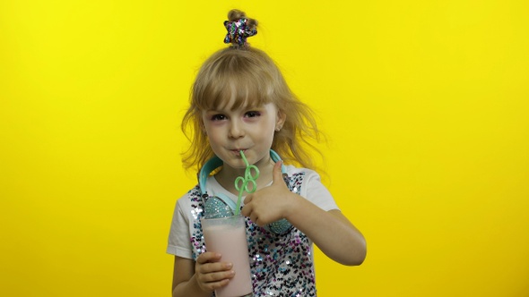 Stylish Child Drinking Milk Cocktail Through Straw and Showing Thumb Up. Cold Milkshake Drink