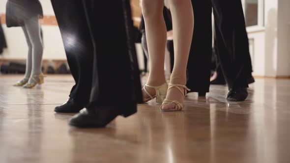 Legs of Caucasian Boys and Girl Dancing Latin Ballroom Dance in Studio