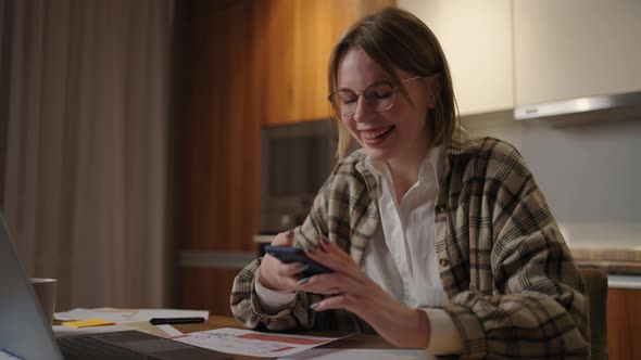 Businesswoman Holding Modern Smart Phone Texting Message in Office