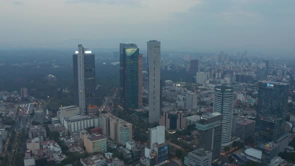 Ascending Aerial View of Tall Glass Skyscrapers Rising Above Modern Urban City Center of Mexico City