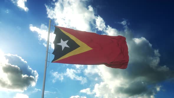 Flag of East Timor Waving at Wind Against Beautiful Blue Sky