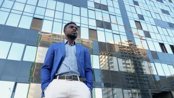 African American Businessman Stands Thinking About Job