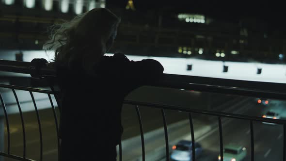 Woman Enjoying City View Cars Passing at Night Street in Downtown