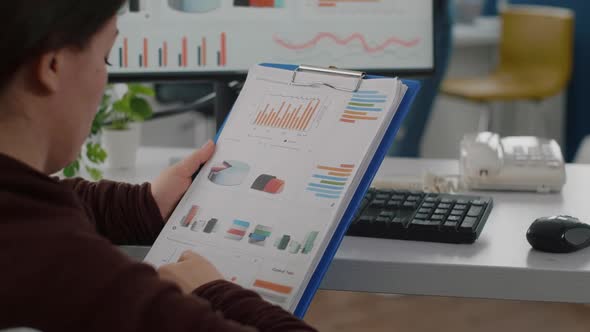 Close Up of Invalid Disabled Company Director Reading Project Documents