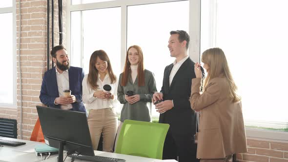 Group of Young Managers Communicating During Meeting