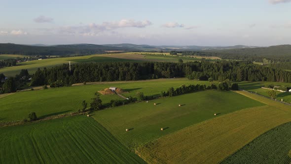 Aerial drone view of meadow near village and forest. Summer in Czechia
