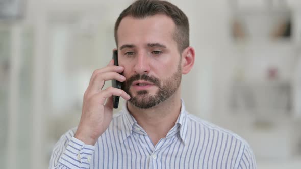 Portrait of Cheerful Young Man Talking on Smartphone 