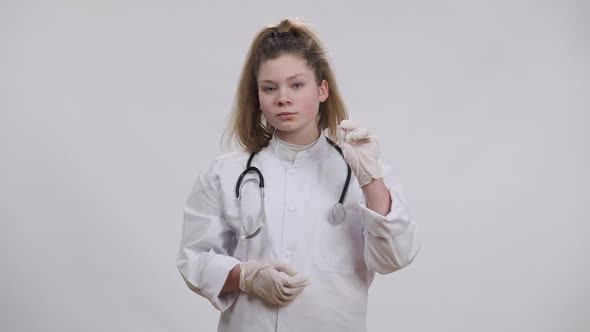 Confident Little Doctor Shaking Finger Looking at Camera with Serious Facial Expression