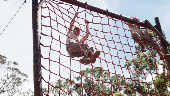 Military troops climbing a net during obstacle course 4k