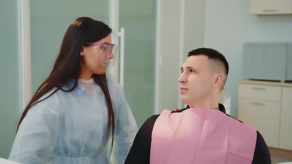 Caucasian Female Doctor and Male Patient at Doctor's Office