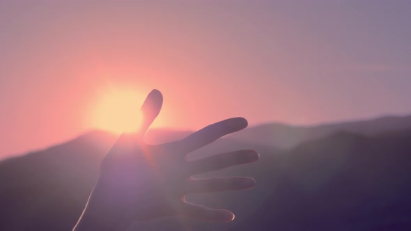 Female Hands Playing with Sun Light Against the Sky Pass Sun Beams