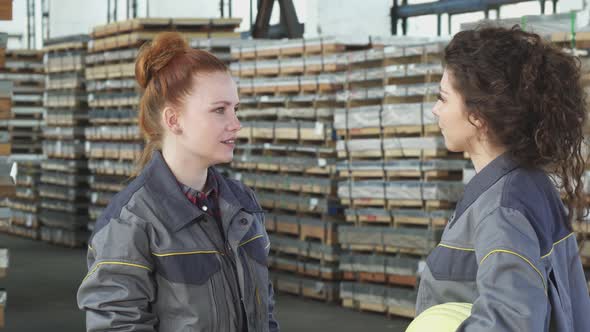 Young Happy Female Factory Workers High Fiving at the Warehouse