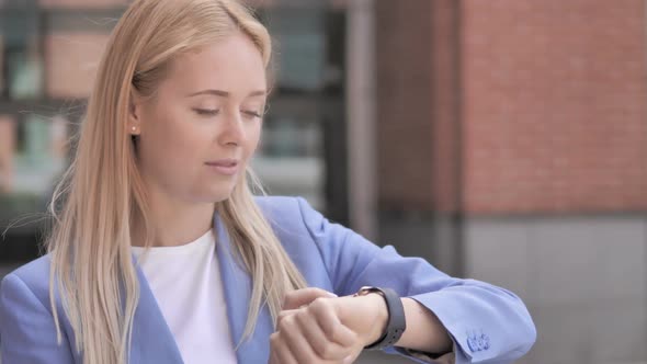 Young Businesswoman Using Smartwatch Outdoor