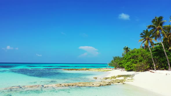 Luxury drone copy space shot of a sunshine white sandy paradise beach and aqua turquoise water backg