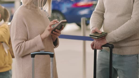 Couple Standing In Queue For Check-In