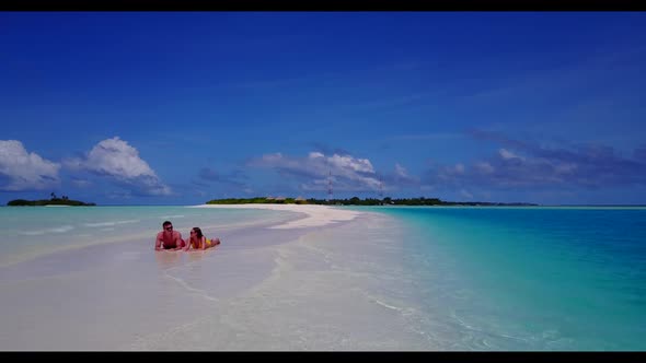 Two lovers happy together on paradise lagoon beach holiday by transparent lagoon with white sandy ba