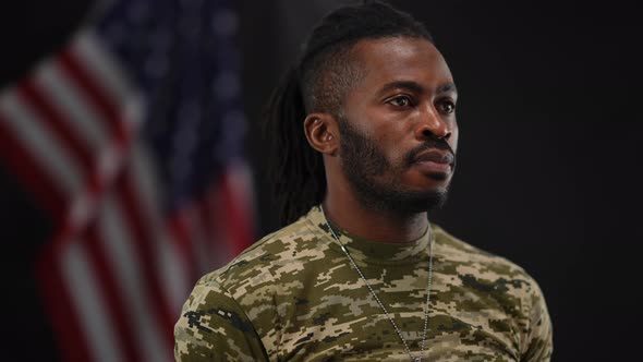 Portrait of Confident Brave African American Man in Military Tshirt Looking Away Standing at Black