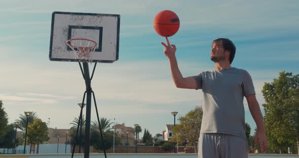 Basketball Ball Balancing and Spinning on a Finger Player on an Outdoor Basketball Court