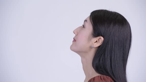 Closeup Profile View of Happy Beautiful Asian Woman Looking Up