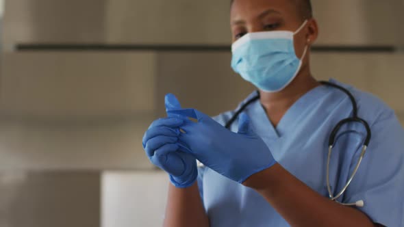 African american female doctor wearing face mask and gloves