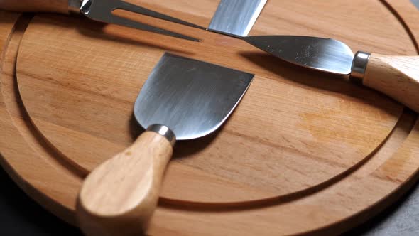Cheese Knifes and Fork on Wooden Platter