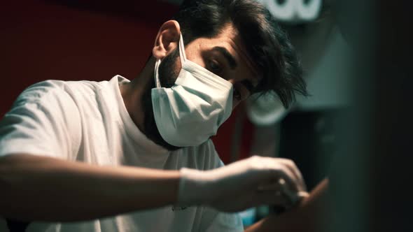 Young Man Doing a Tattoo