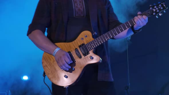 Guitarist at a Rock Concert Plays Electric Guitar on the Open Stage. Slow Motion