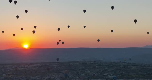 Aerial Cinematic Drone View of Colorful Hot Air Balloon Flying Over Cappadocia