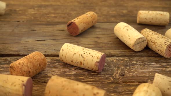 Falling wine corks on old wooden vintage boards. Slow motion.